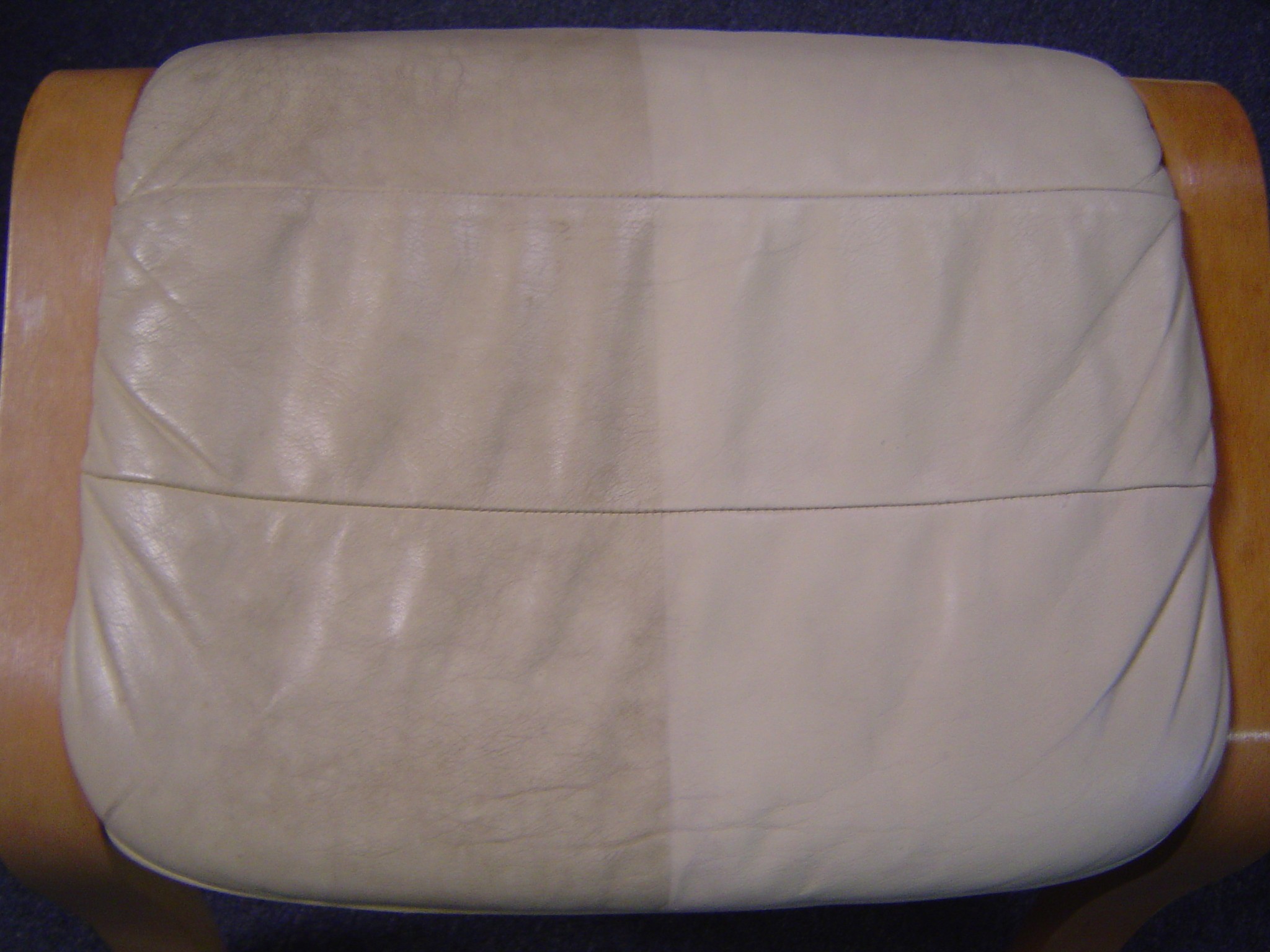 Leather sofa before and after Chem-Dry cleaning — left side dirty, right side clean