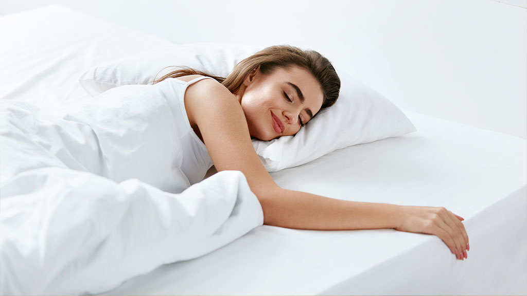 Woman sleeping peacefully on a clean mattress